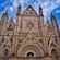 La fachada de una catedral gótica con intrincados mosaicos, grabados detallados y altas torres.